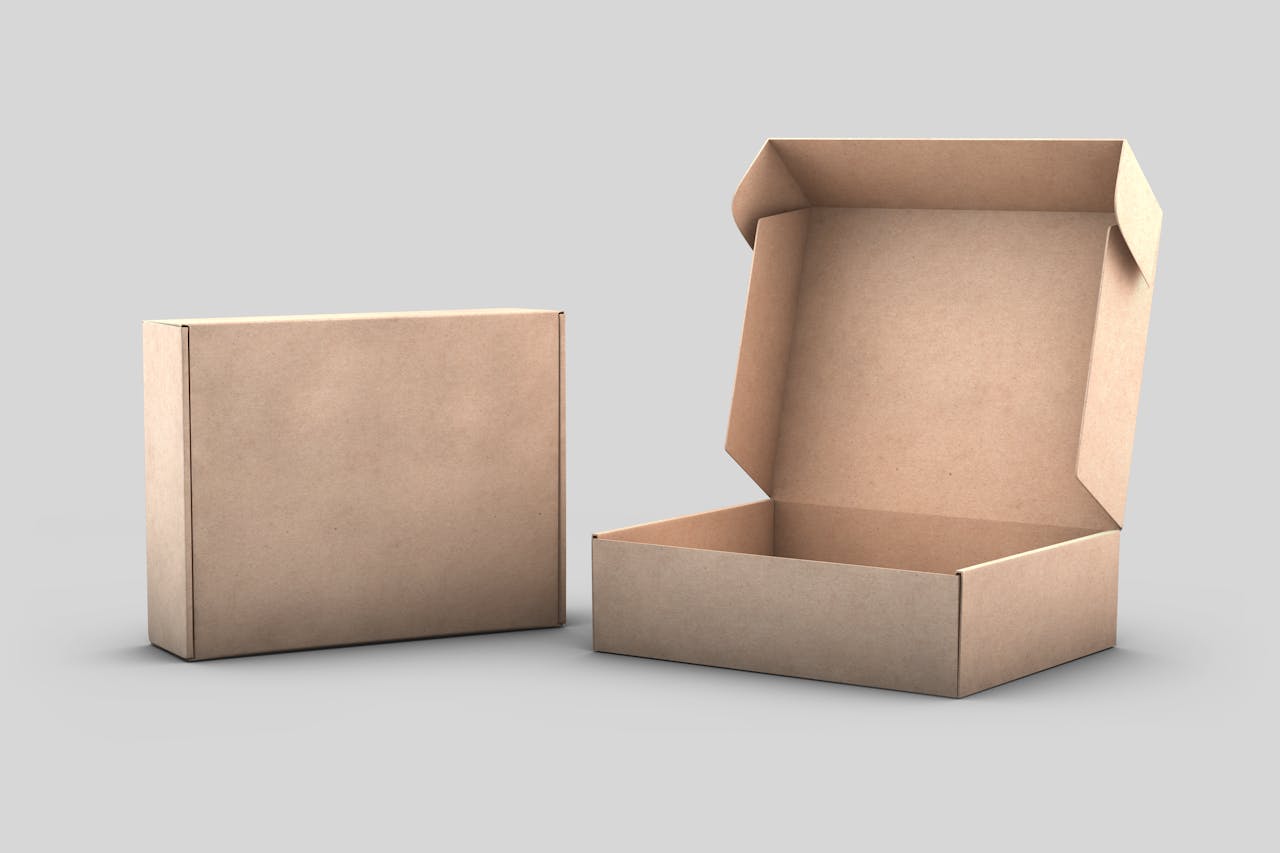 Two cardboard boxes, one closed and one open, on a white background for packaging concepts.